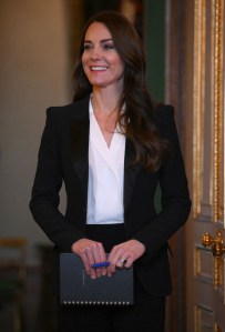 At the Windsor Castle meeting of the new advisory board, Kate wore an Alexander McQueen tuxedo jacket, Holland Cooper bodysuit, and Roland Mouret trousers. Her earrings were from Shyla London.