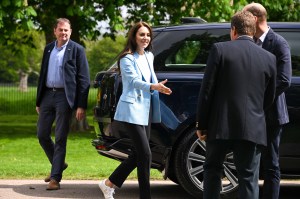 At a lunch celebrating the coronation, Kate wore a sky blue Reiss jacket, LK Bennett trousers, and Veja sneakers.