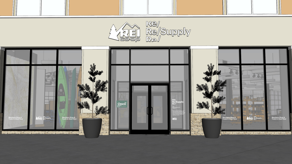 A rendering of an REI used 'Re/Supply' storefront complete with glass paned windows, shrubbery and a glimpse inside at kayak rentals.