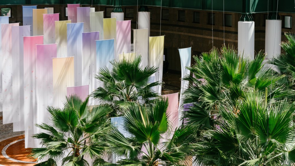 Miya Ando's Brookfield Place installation features flowers from every season paired with the venue's palm trees.