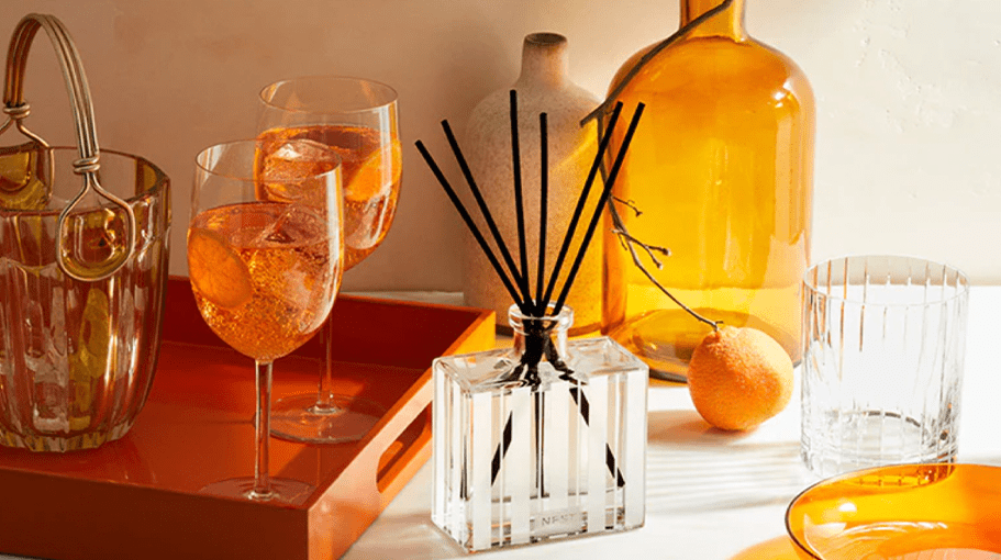 tabletop with wine glasses, diffuser, plates, and vases