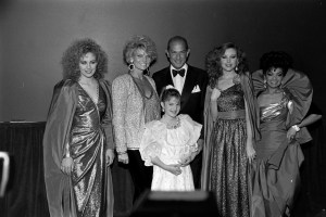 Drew Barrymore, Genie Francis, Cathy Lee Crosby, Oscar de la Renta, Rebecca Holden, and Suzette Charles attend an event, celebrating the introduction of Barbie dolls wearing fascimilies of Oscar de la Renta fashion designs in 1985.