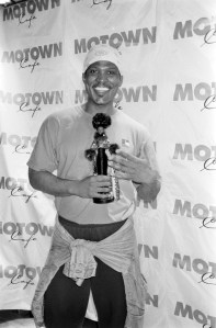 Byron Lars with his African-American Barbie, the first in the series designed for Mattel's runway collection series in 1997.