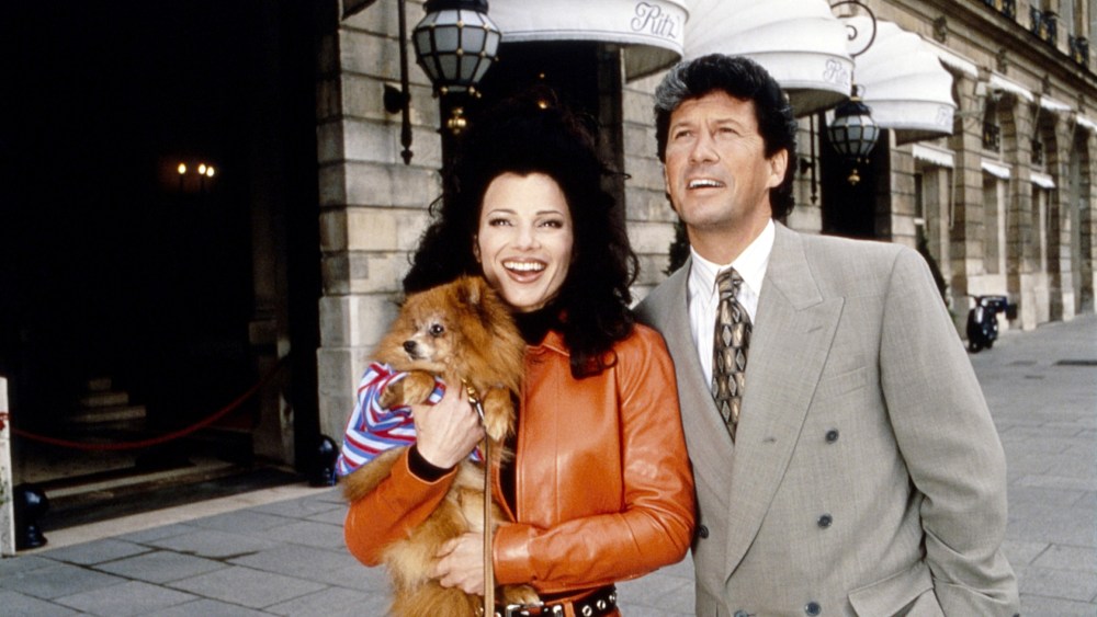 THE NANNY, from left,  Fran Drescher (holding Chester the dog), Charles Shaughnessy, on location in London, 'Fran's Gotta Have It' (season 4, aired May 21, 1997), 1993-99. ©CBS / courtesy Everett Collection