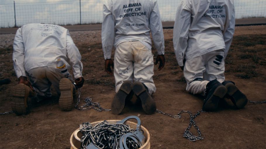 Convicts at the Limestone Correctional facility are placed back onto the chain gang when they leave the prison grounds for their daily labor as road crews in July of 1995 outside of Huntsville, Alabama.