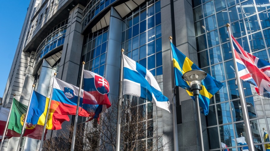 European national flags in front of European Parliament building in Brussels, Belgium.