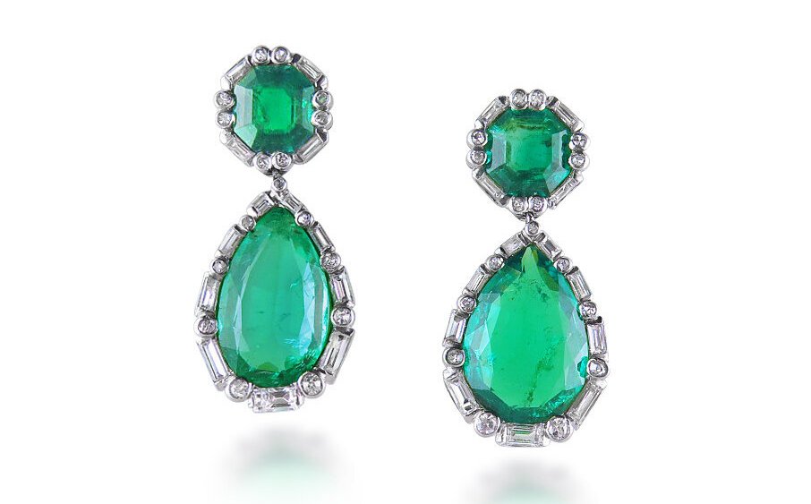 Emerald teardrop earrings surrounded by baguette and round diamonds in an art deco pattern.