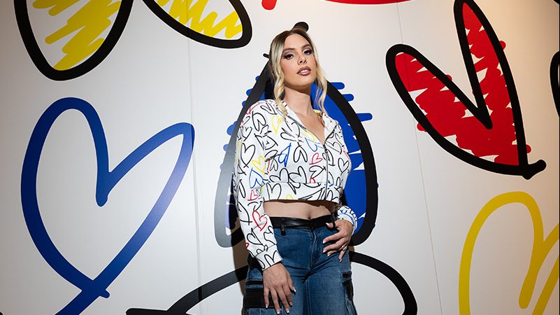 Lele Pons in the Barron cropped wide-sleeve zip-up hoodie ($395) from her collaboration with Alice + Olivia in partnership with Airbnb.org.