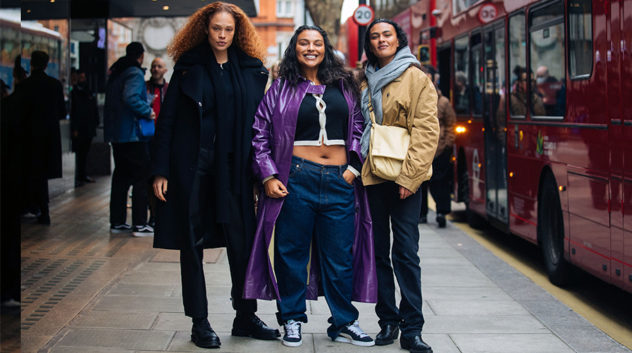 Models Sabina Karlsson, Paloma Elsesser, and Ylang Messenguiral after the Nensi Dojaka show at The Flipside at Old Selfridges Hotel during London Fashion Week Fall/Winter 2022 on February 19, 2022 in London, England. Sabina wears all black .Paloma wears a purple leather trench, black and white cropped cardigan, blue jeans, and black Puma suede sneakers. Ylang wears a gray scarf, light brown Polo jacket, yellow tan messenger bag, black jeans, and black boots.