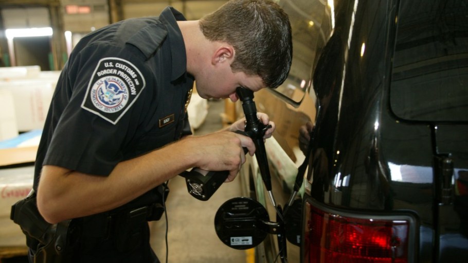 A CBP officer inspects a shipment.
