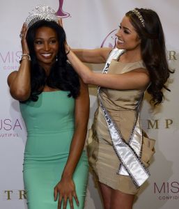 The new Miss USA Nana Meriwether (c)  is crowed by newly appointed Miss Universe Olivia Culpo (L) at the Trump Tower January 9, 2013. Nana Meriwether, first runner up in the Miss USA 2012 Pageant will be taking over Miss USA's reign after Olivia Culpo won the Miss Universe 2012 title, the last time this happened was 1997. AFP PHOTO / TIMOTHY A. CLARY        (Photo credit should read TIMOTHY A. CLARY/AFP via Getty Images)