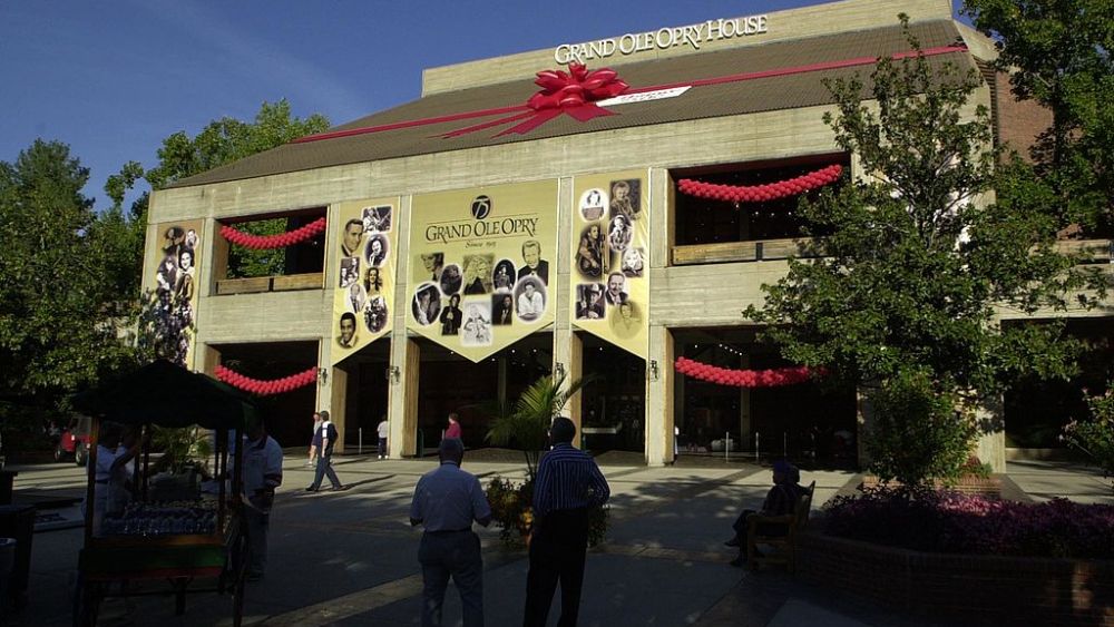 NASHVILLE, :  The Grand Ole Opry House in Nashville, Tennessee, is shown wrapped in a red bow in honor of the Grand Ole Opry's 75th Birthday on 13 October 2000. A celebration to mark the event will be held 13-14 October evenings with several stars who will cut a birthday cake. AFP PHOTO/Neil BRAKE (Photo credit should read NEIL BRAKE/AFP via Getty Images)