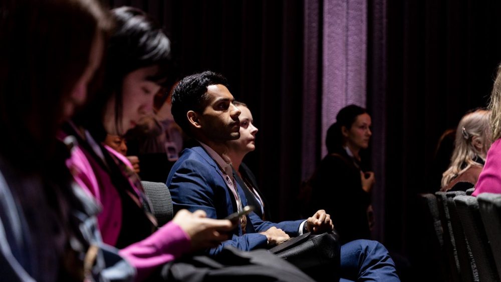 A view of the attendees dimly lit and attentive at the Global Fashion Agenda's first Boston edition after years in Copenhagen.