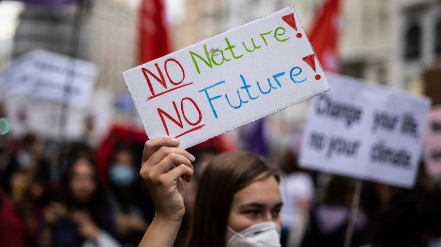 A protestor’s sign reads “No Nature, No Future.”