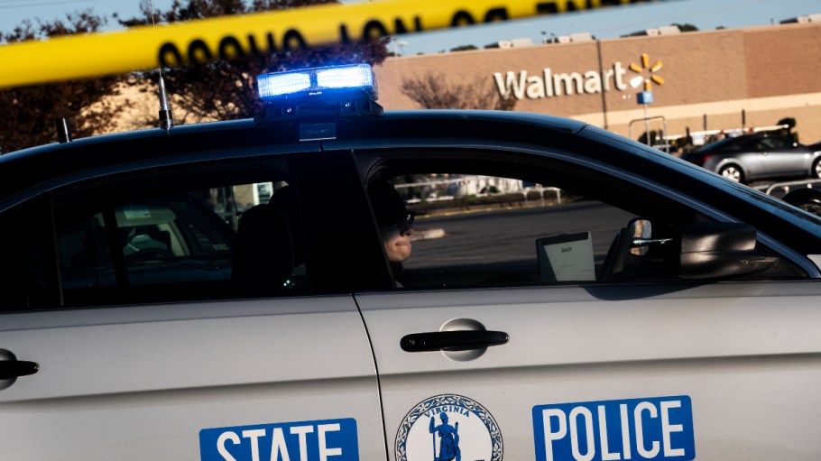 CHESAPEAKE, VA - NOVEMBER 23: A Virginia State Police officer watches the police line set up at the site of Tuesdays fatal shooting at the Chesapeake Walmart Supercenter on November 23, 2022 in Chesapeake, Virginia. Six people, including the suspected gunman, are dead following the Tuesday night shooting.