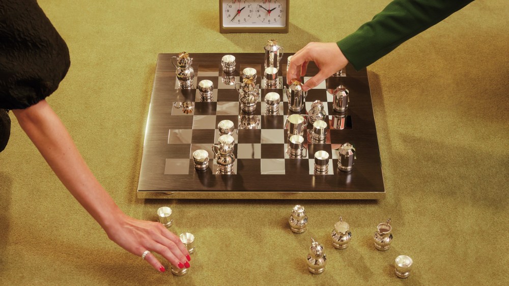 The Christofle Christmas 2023 campaign, featuring a chess board with miniature tea sets as pieces.