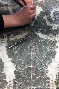 Iris van Herpen’s atelier hand-stitched thousands of separately 3D-printed elements reversed to the back side of a tulle base for the ‘Lucid’ dress.