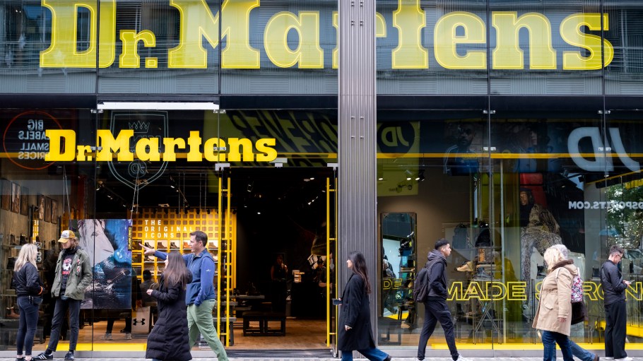 Shoppers and visitors out on Oxford Street pass the Dr Martens shop in London, United Kingdom.