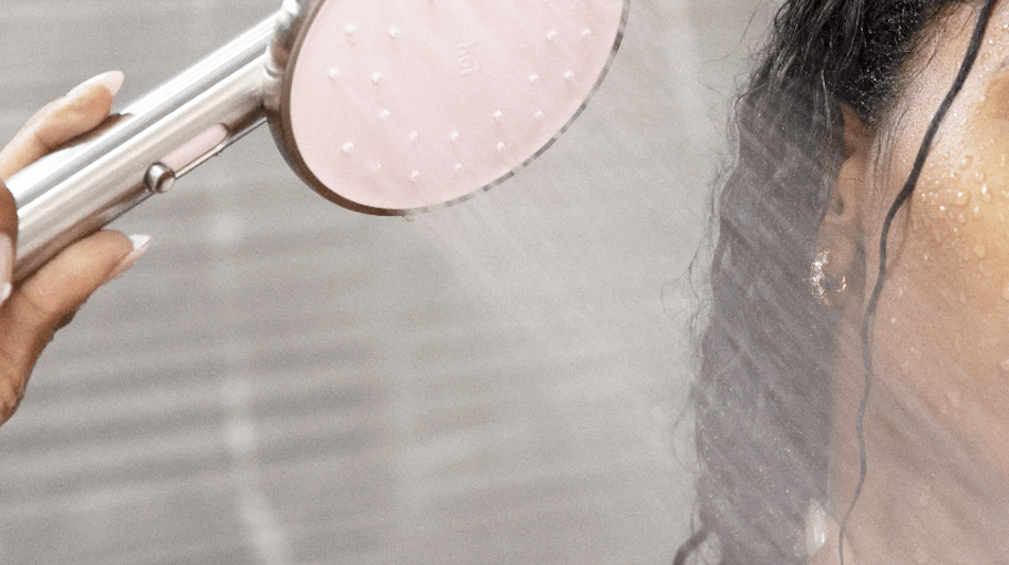 woman with a shower head that's one of the best spa gifts