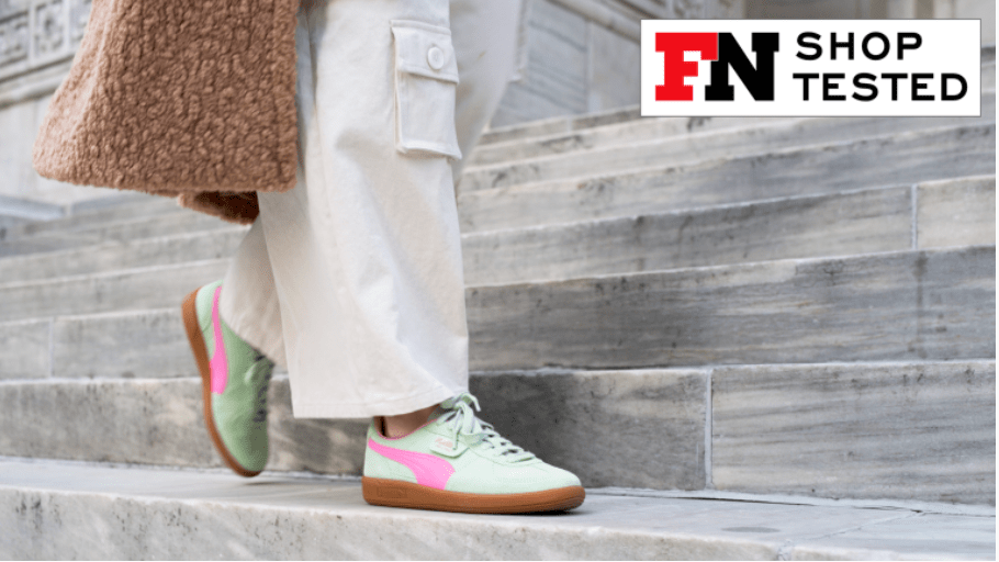 woman wearing a pair of bright sneakers on marble staircase