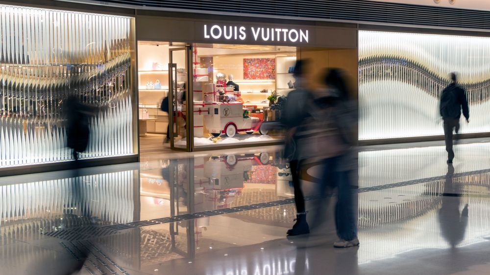 Chinese tourists passing by a Louis Vuitton in Hong Kong, China.