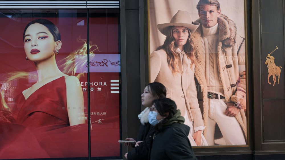 People walk at a shopping mall in Beijing.