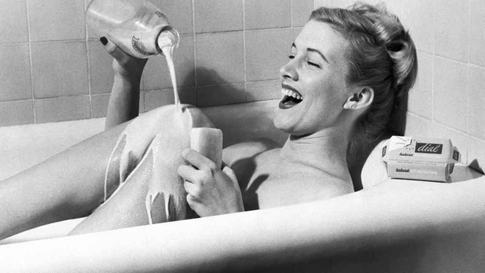 (Original Caption) 12/16/1949-New York, NY: With faucets shut and the milk bottle running, this young lady helps the city with water conservation and herself with an old beauty formula. The formula of milk and suds is supposed to be the best blend for the skin. BPA 2 #452