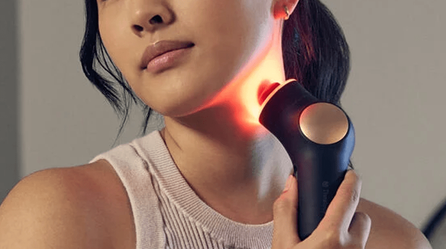woman using a red light therapy tool for skin benefits