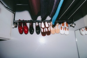 A look at girl in red getting ready for Tory Burch Fall 2024 show.