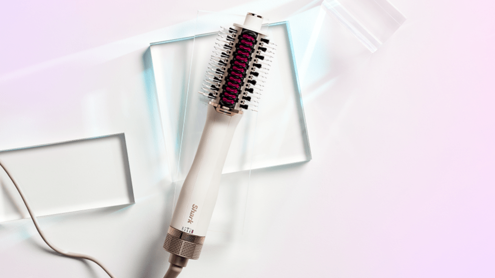 Shark SmoothStyle hair dryer brush on a pink background