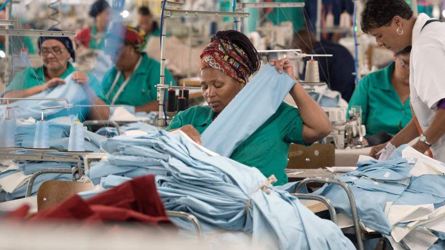 Workers at Kinross Clothing manufacturers in Maitland, sew men's trousers on October 19, 2017, in Cape Town.