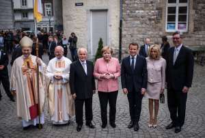 Bishop Helmut Dieser ,Provost Manfred von Holtum, former mayor of Aachen Juergen Linden, German Chancellor Angela Merkel, French President Emmanuel Macron, his wife Brigitte Marie-Claude Macron and mayor of Aachen Marcel Phillip arrive for the International Charlemagne Prize on May 10, 2018 in Aachen, Germany.