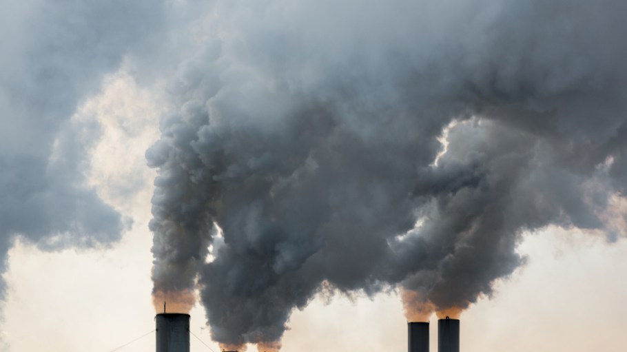 Plumes of smoke rise from chimneys.