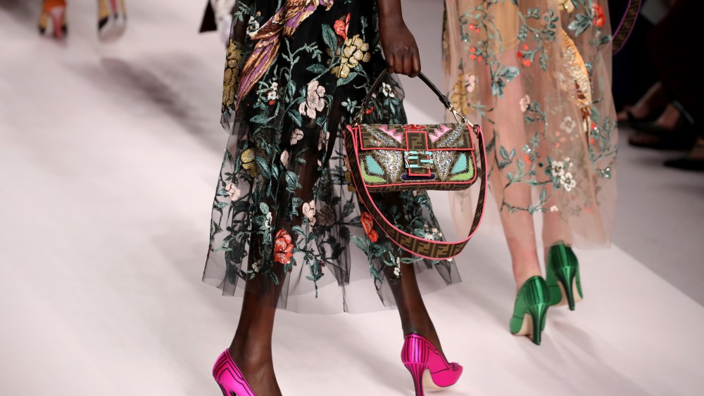 history of fendi baguette, MILAN, ITALY - SEPTEMBER 20:  A model, bag detail, walks the runway at the Fendi show during Milan Fashion Week Spring/Summer 2019 on September 20, 2018 in Milan, Italy.  (Photo by Andreas Rentz/Getty Images)