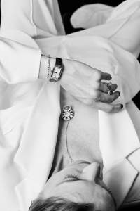 Van Cleef & Arpels “Ludo” secret transformable watch featuring rubies, coral, white mother-of-pearl and diamonds set in 18-karat rose gold; Jaeger-LeCoultre Reverso One Duetto in 18-karat pink gold case; Van Cleef & Arpels “Perlée” ring featuring rubies set in 18-karat rose gold and “Perlée” between the finger ring featuring carnelian and diamonds set in 18-karat rose gold; Chopard Ice cube collection bracelet in 18-karat rose gold set with diamonds; Sans Faff naia acetate, polyester crepe, Lenzing EcoVero and viscose suit.