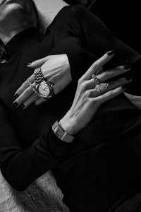 Top hand: IWC Ingenieur Automatic 40 in stainless steel; Material Good pear-shape tennis bracelet.Bottom hand: Chanel Code Coco watch in white gold and diamonds; Boucheron Serpent Bohème XL Motif Ring pavéd with diamonds, in white gold; Boochier Jumbo 18-karat recycled yellow gold and white diamond Slinkee ring.Tom Ford compact slinky viscose turtleneck evening dress.