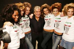 Designer Roberto Cavalli backstage with his models at the Spring 2004 Roberto Cavalli show in Milan.