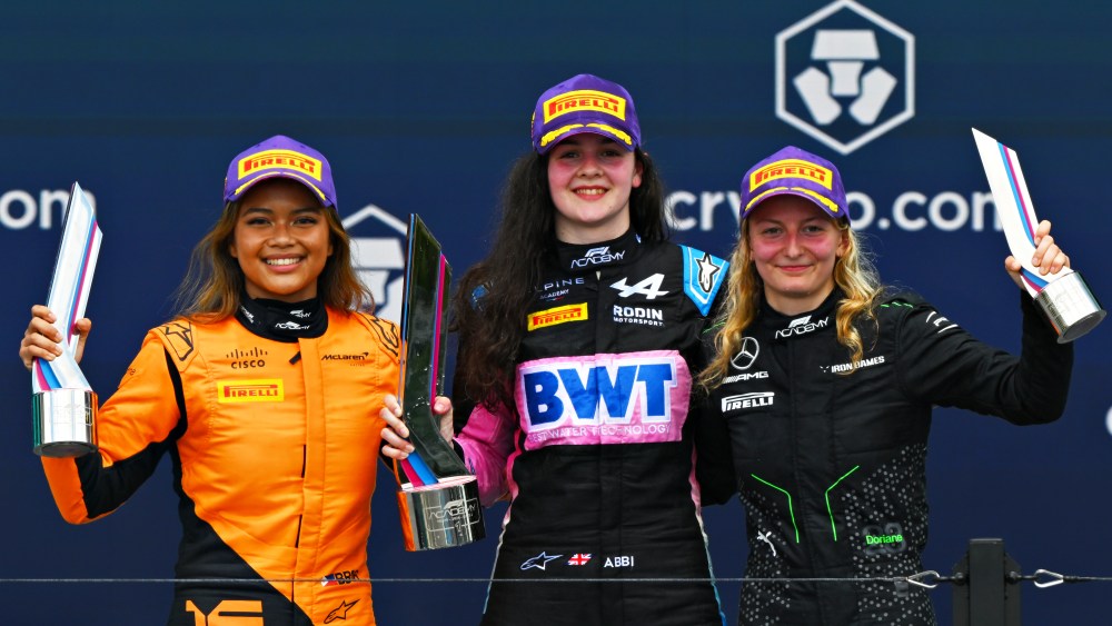 MIAMI, FLORIDA - MAY 05: Race winner Abbi Pulling of Great Britain and Rodin Motorsport (9), Second placed Bianca Bustamante of Philippines and ART Grand Prix (16) and Third placed Doriane Pin of France and PREMA Racing (28) celebrate on the podium during Round 2 Miami race 2 of the F1 Academy at Miami International Autodrome on May 05, 2024 in Miami, Florida. (Photo by Clive Mason/Getty Images)