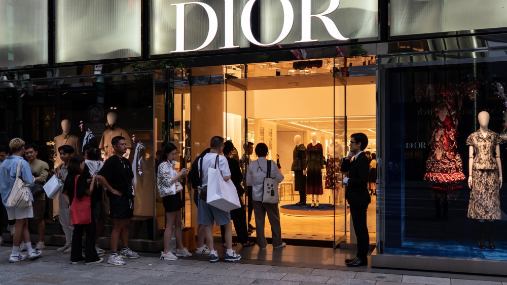 Chinese tourists wait in line outside a Dior store in the Ginza district in Tokyo, Japan.
