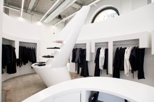 Radical white fixtures and rounded shapes heighten the spaceship feeling of the store.