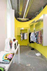 Rei Kawakubo lined some of her elliptical walls with bold color, like this one in chartreuse.