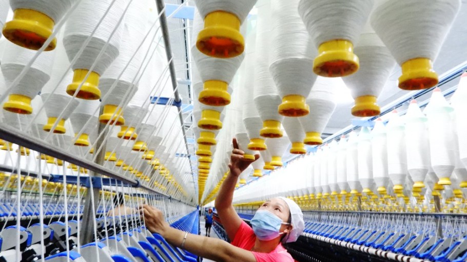 A worker producing cotton products for export to Europe and the United States at a workshop of a textile printing and dyeing company in Sichuan Province, China.