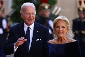 President Joe Biden and US first lady Jill Biden in Schiaparelli dress, blue velvet gown, pose ahead of an official state dinner as part of US President's state visit to France on June 08, 2024 in Paris, France. U.S. President Joe Biden is in France to commemorate the 80th anniversary of the invasion of Normandy and to emphasize the continued role of the United States in helping to protect democratic values in Europe. (Photo by Marc Piasecki/Getty Images)
