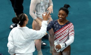Simone Biles of Team United States reacts with teammate Hezly Rivera after finishing her routine on the uneven bars during the Artistic Gymnastics Women's Team Final on day four of the Olympic Games Paris 2024 at Bercy Arena on July 30, 2024 in Paris, France.