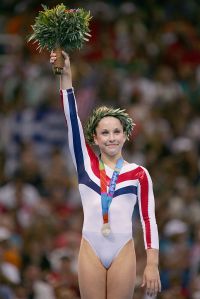 ATHENS - AUGUST 23:   Carly Patterson of United States receives the silver medal for the women's artistic gymnastics balance beam event on August 23, 2004 during the Athens 2004 Summer Olympic Games at the Olympic Sports Complex Indoor Hall in Athens, Greece. (Photo by Ezra Shaw/Getty Images)