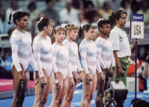 BARCELONA - JULY 28:  The team from the United States (L-R Betty Okino, Wendy Bruce, Kim Zmeskal, Shannon Miller, Kerri Strug, Dominque Dawes) prepare to compete on July 28, 1992 during the Team All-Around event of the Women's Gymnastics competition of the 1992 Summer Olympics held at the Palau Sant Jordi in Barcelona, Spain.  (Photo by David Madison/Getty Images)