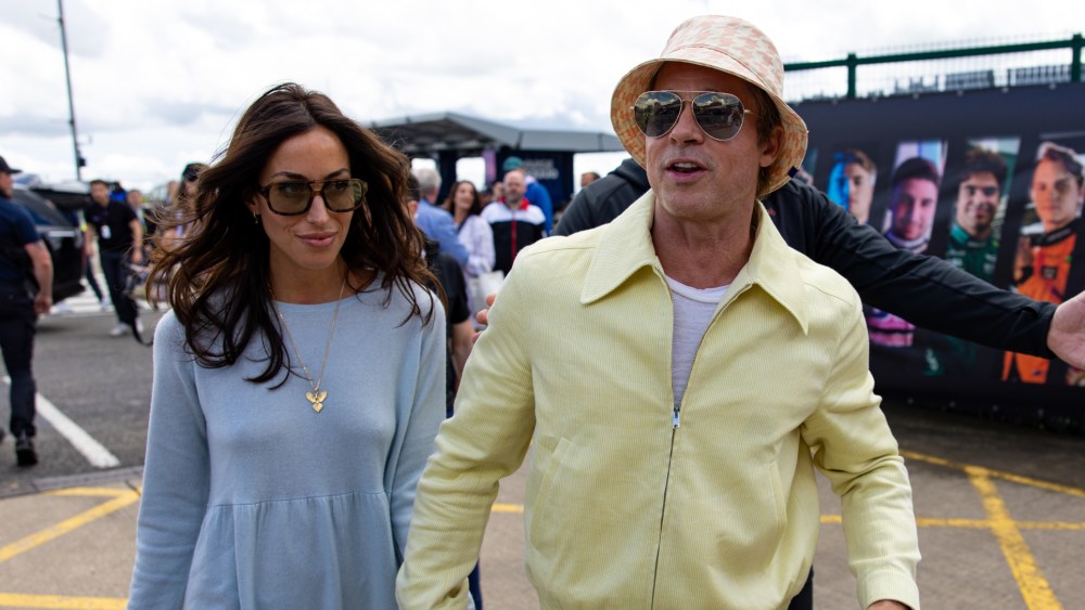 Brad Pitt and girlfriend Ines De Ramon walk in the paddock during the F1 Grand Prix of Great Britain at Silverstone Circuit on July 7, 2024 in Northampton, United Kingdom.