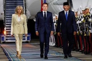 France's President Emmanuel Macron (C) and his wife Brigitte Macron (L) are welcomed by Indonesia's Defence Minister Sjafrie Sjamsoeddin (R) upon arrival at Halim Perdanakusuma International Airport in Jakarta on May 27, 2025. (Photo by Ludovic MARIN / AFP) (Photo by LUDOVIC MARIN/AFP via Getty Images)