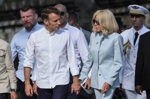 France's President Emmanuel Macron (L) and his wife Brigitte Macron speak during a visit at Borobudur Temple, the world's largest Buddhist monument and a UNESCO World Heritage Site, in Magelang, Central Java, on May 29, 2025. (Photo by YASUYOSHI CHIBA / POOL / AFP) (Photo by YASUYOSHI CHIBA/POOL/AFP via Getty Images)