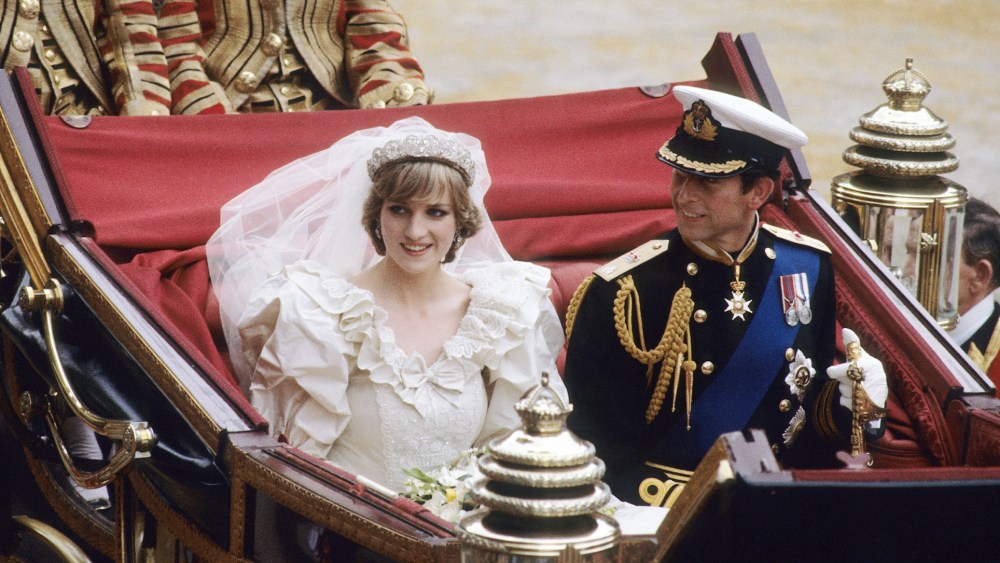 LONDON, ENGLAND - JULY 29: Prince Charles, Prince of Wales and Diana, Princess of Wales, wearing a wedding dress designed by David and Elizabeth Emanuel and the Spencer family Tiara, ride in an open carriage, from St. Paul's Cathedral to Buckingham Palace, following their wedding on July 29, 1981 in London, England. (Photo by Anwar Hussein/WireImage)